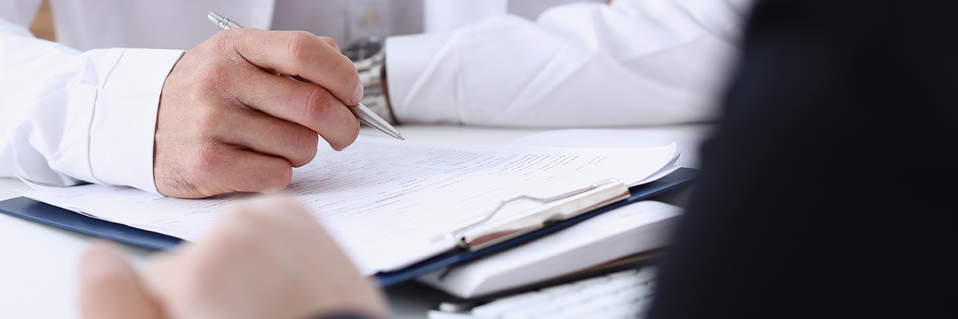 Doctor discussing medical history with patient during a routine gynaecology appointment