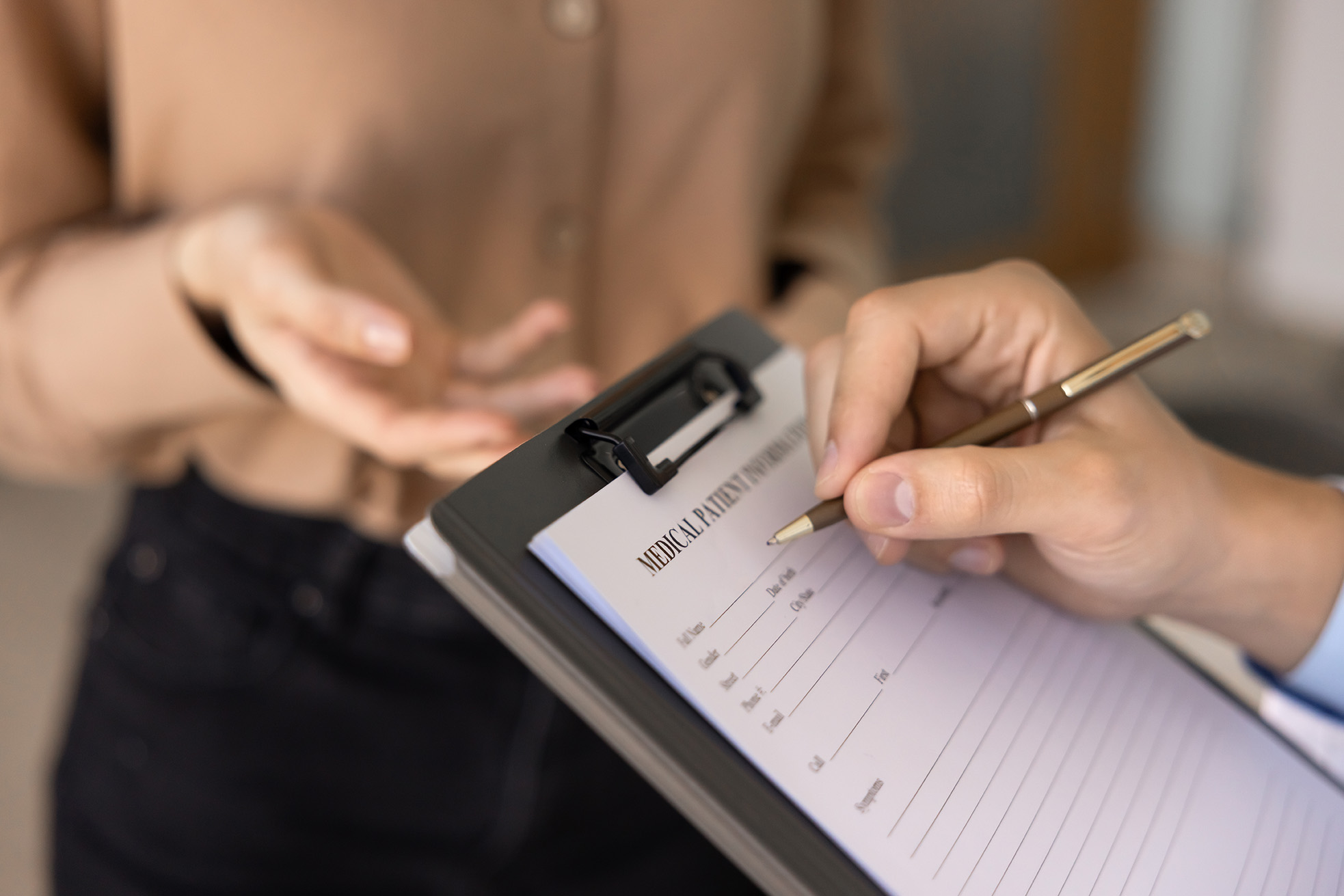 Gynaecologist discussing medical history with patient during a routine consultation